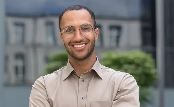 Young professional black man wearing glasses smiling at camera